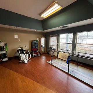 A spacious rehabilitation area equipped with exercise machines and ample natural light.