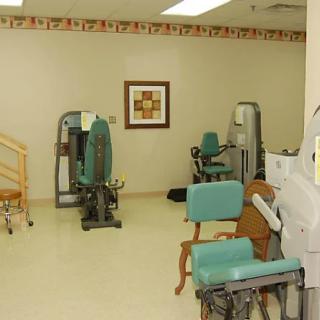 A rehabilitation room equipped with exercise machines and therapy equipment.