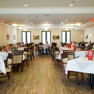 An elegant dining room with neatly arranged tables and chairs.