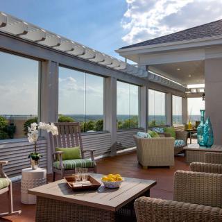 A well-furnished rooftop terrace with comfortable seating and a scenic view.