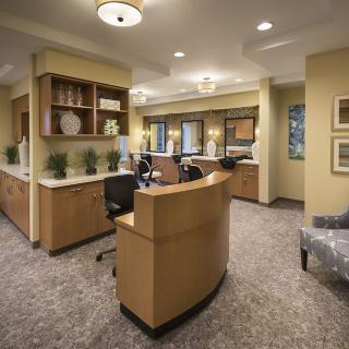 A modern reception area with stylish furniture and warm lighting.