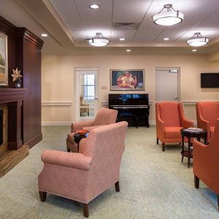 A cozy living space with comfortable seating and a piano.