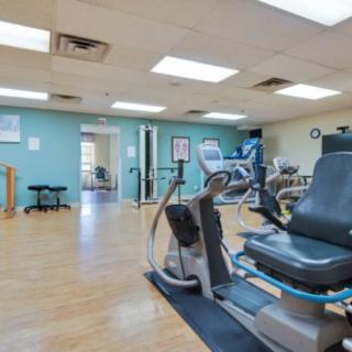 An indoor gym with various fitness equipment and exercise machines.