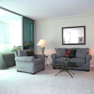 A modern living room with gray furniture and elegant decor.