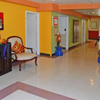 A vibrant corridor with colorful walls and decorative furnishings.