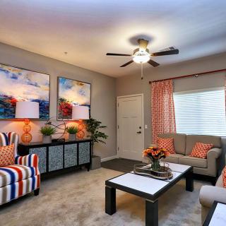 A cozy living room with stylish furniture, colorful artwork, and ambient lighting.