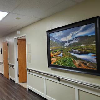A serene landscape photograph hangs on a corridor wall, adding a touch of nature to the interior.