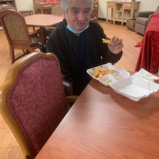 A person enjoying a meal at a dining table.