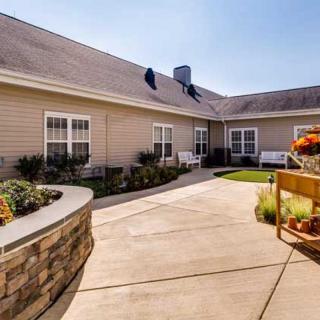 A charming courtyard with a patio area surrounded by a landscaped garden.