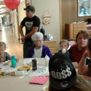 A family gathering with children and adults enjoying time together indoors.