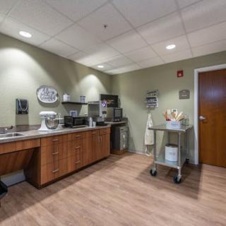 Office breakroom with appliances and cabinets.