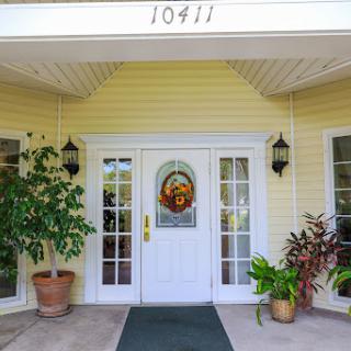 The welcoming entrance of a charming home with decorative plants.