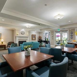 A spacious and elegantly decorated communal living and dining area with comfortable seating.