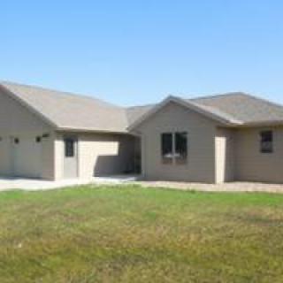 A single-story suburban house with a manicured lawn.