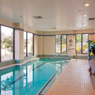 A serene indoor swimming pool offering a tranquil space for relaxation and exercise.