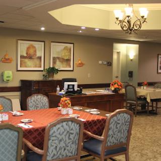 A cozy dining area with well-set tables and artistic decor.
