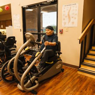 A person engaged in a workout session on a specialized exercise machine in a fitness facility.