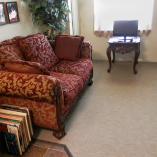 A cozy living room with a patterned sofa and a small wooden table.