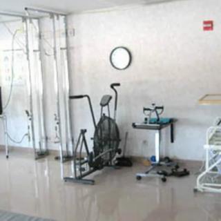 A therapy room equipped with exercise machines for rehabilitation.
