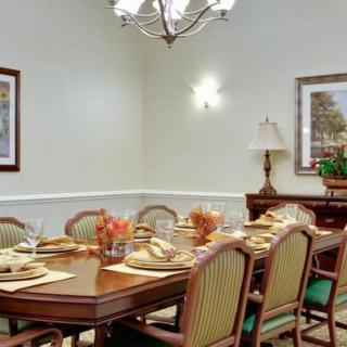 A formal dining room with an elegantly set table and classic decor.