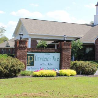 Entrance sign at Providence Place of the Pines property.