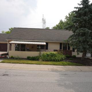 A cozy suburban house with a well-maintained front yard.