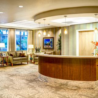 A spacious and elegantly designed hotel lobby with a reception desk and comfortable seating area.
