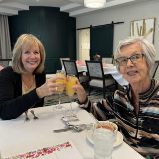 Two friends enjoying a cheerful brunch together.