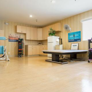 A modern kitchen space featuring light wood cabinetry and minimalist furniture.