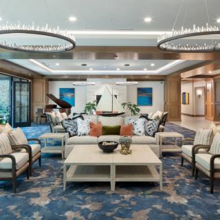 A luxurious living room interior featuring elegant furnishings and a grand piano.