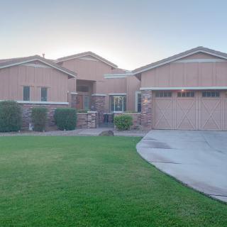 A suburban house with a brick exterior and a neatly maintained front yard.