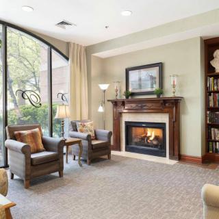 A cozy living room with a fireplace and comfortable seating.