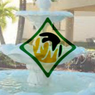 A decorative fountain featuring a unique logo amidst a serene outdoor setting.