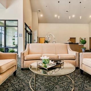 A sophisticated and modern lobby featuring elegant sofas and a decorative round table.