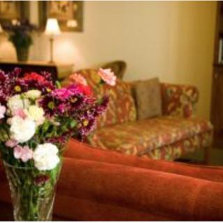 A cozy living room with a floral arrangement in the foreground.