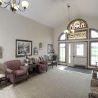 A cozy lobby with comfortable seating and decorative windows.