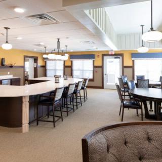 A modern dining area with stylish seating and ample lighting.