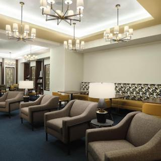 A cozy lounge area featuring modern furniture and ambient lighting.