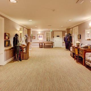 A well-decorated hallway with furniture and subtle lighting.
