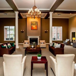 Spacious lounge with elegant furniture and a chandelier.