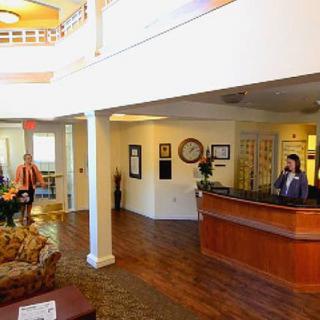 A welcoming hotel lobby with a front desk and seating area.