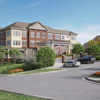 A picturesque residential building surrounded by a lush landscape with parked cars in the driveway.