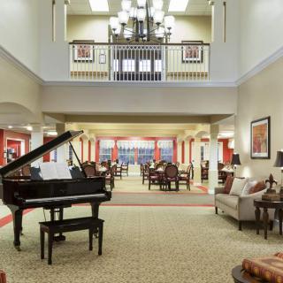 Spacious lobby with a grand piano and comfortable seating area.