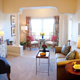 A cozy and well-lit living room with elegant furniture and decor.
