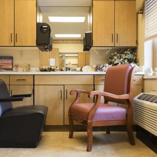 A small office space with chairs, a desk, and cabinets.