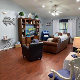 A cozy living room featuring comfortable seating, a television set, and tasteful decor.