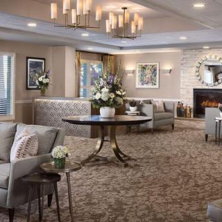 A cozy living room with elegant furnishings and a warm fireplace.