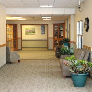 A welcoming hallway featuring comfortable seating and decorative plants.