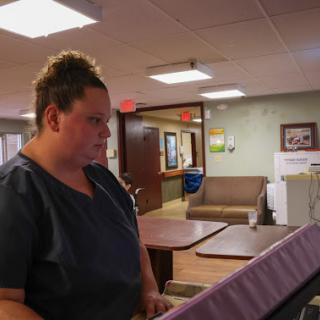 A nurse engaged in her work at a healthcare facility.