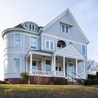 A classic Victorian-style house with a turret and gable roof.